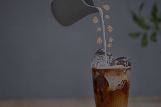Almond milk pouring in coffee