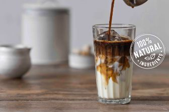 Coffee pouring in milk and 100% natural ingredients logo